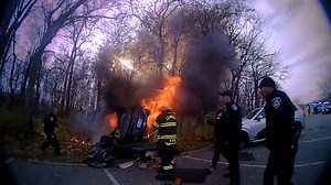 Watch: Crews race to rescue woman trapped under burning car