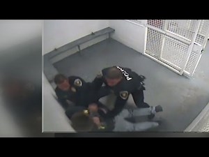 Video shows officers use force on handcuffed suspect in jail cell
