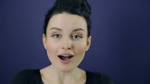 Portrait of a excited woman on blue background - Free Stock Video
