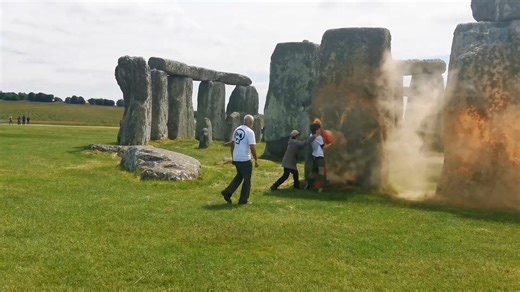 Before thousands gather at Stonehenge for the summer solstice, climate protesters demanding action sprayed orange powder over the iconic structure. | USA TODAY