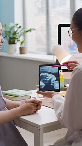 Doctor showing ultrasound to pregnant woman | Free Stock Video Footage