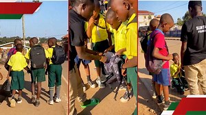 Heartwarming: Boy carrying books in nylon bag kneels as well-wisher gifts him