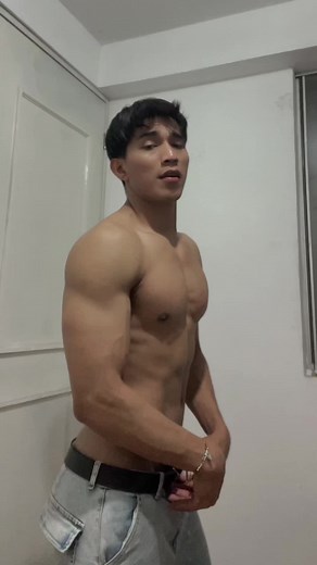 Muscular Male Physique Showcase in Indoor Setting