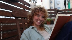 Woman expressing different emotions while reading book