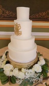 1.3K views · 33 reactions | Classic, Stunning White Buttercream Wedding Cake with Sugar Pearls & Gold Monogram.... surrounded by all white flowers and greenery... cakes like this take my breath away. The cake flavor was also classic... White Almond Sour Cream with Vanilla Buttercream. The monogram was hand-cut and painted. | RoseBakes.com | Facebook