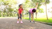 mother and daughter exercising on a park, Slow motion