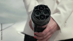 Female hands disconnect and show DC fast charging socket Japan type. Business woman holding an electric car plug of EV. Eco friendly alternative energy green environment concept vídeo de Stock