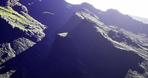 CGI Dramatic mountain landscape with shadows and vibrant greenery at dawn