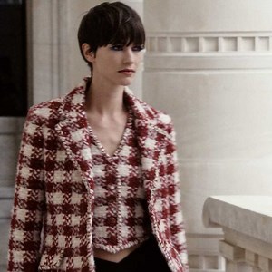 A boxy jacket and matching waistcoat in chequered raspberry tweed is worn above a V-waist ball skirt in silk mikado, playing masculine tailoring against the ultra feminine.​ ​The CHANEL Fall-Winter 2021/22 Haute Couture collection.​ ​See more at chanel.com/-HC_FW21-22_HC​ ​Special thanks to Paris Musées and the Palais Galliera. | CHANEL