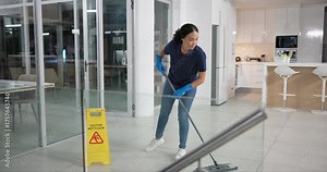 Woman, cleaner and and mop in office with cleaning service in janitor workspace and kitchen at night. Person or maid with caution wet floor sign, working and housekeeping job at company for hygiene