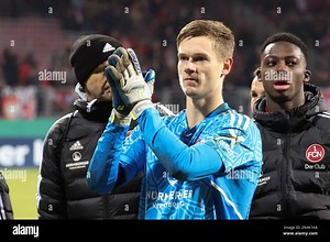 Nuremberg, Germany. 08th Feb, 2023. Soccer: DFB Cup, 1. FC Nuremberg - Fortuna Düsseldorf, Round of 16 at Max Morlock Stadium. Nuremberg goalkeeper Peter Vindahl Jensen (center) celebrates the victory with his colleagues. Credit: Daniel Karmann/dpa - IMPORTANT NOTE: In accordance with the requirements of the DFL Deutsche Fußball Liga and the DFB Deutscher Fußball-Bund, it is prohibited to use or have used photographs taken in the stadium and/or of the match in the form of sequence pictures and/o