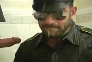 Horny cop draining a cock and smoking cigar