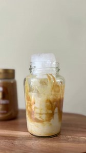🥜 Easy peanut butter iced coffee 🙌☕ - Grab an empty jar or a glass - Drizzle peanut butter around the sides and squeeze extra in the bottom - Add your preferred milk, about half way - Froth the milk and peanut butter together - Add some ice - Top with cooled coffee - Stir together, and enjoy! #wholeearthdrizzler #wholeearthpeanutbutter #wholeearthfoods #peanutbutteraddict #peanutbutterlover #peanutbutterfrappe #peanutbuttercoffee | Whole Earth Foods