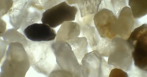 clip-1101791165-sand-under-miscroscope-rock-microscope-crystals-scope