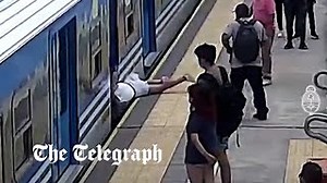 Watch: Shocking moment woman falls under moving train, narrowly avoiding death