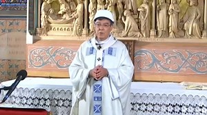 Priests wear hard hats for Notre Dame mass