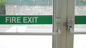 emergency exit sign on a door inside of a building