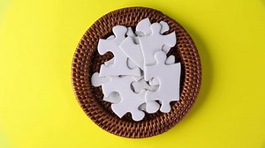 Rotation of white jig saw puzzle