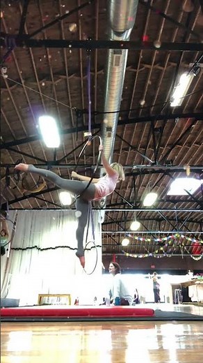 Graceful aerial hoop artist showcasing impressive acrobatic flexibility and balance mid-ai