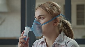 Girl using a nebulizer with mask - Free Stock Video