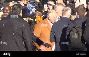 Screen grab taken from PA Video of close-protection officers ushering King Charles III away from the crowd as he was meeting members of the public during a visit to Luton. A man in his 20s has been arrested on suspicion of common assault during a walkabout by the King in Luton town centre after an egg is believed to have been thrown in the direction of the monarch. Picture date: Tuesday December 6, 2022 Stock Photo - Alamy