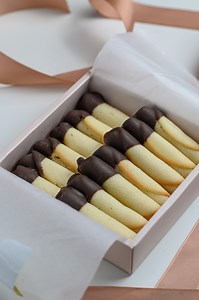 Craving for cookies? Try DLA's Cigarette Cookies dipped in DLA Coklat Milk Chocolate Compound. Full recipe below: Ingredients: - 35g butter - 35g powdered sugar - 35g egg white - all-purpose flour 30g - almond powder 5g - DLA Coklat Milk Chocolate Compound 50g Preparation: - bring butter to room temperature Method: 1. Put butter and powdered sugar in a bowl and mix with a whisk. 2. Add the egg whites little by little and mix well each time. 3. Sift in all-purpose flour and almond powder and mix 