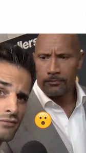 It seemed to be a joke but the reporter confessed he had to watch the footage to find out that the Rock had made this “vulgar” gesture while he was looking at the camera. | Icons