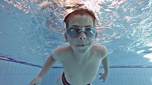 Boy swimming in the pool, underwater shot