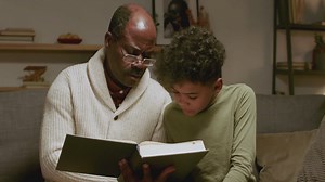 Old black man and boy reading a book | Free Stock Video Footage