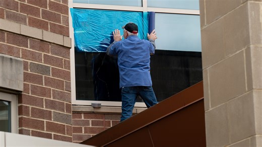Windows are repaired at Buchtel CLC in Akron after they were damaged by gunfire