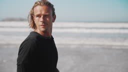 Handsome man walking at beach