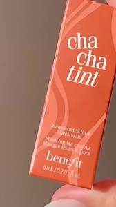 This is the tint of fall 🍂 Apply one coat of Cha Cha Tint with the precise, doe-foot applicator for a sheer hint of tint or layer for more vibrant colour that lasts all day✨️ HOW TO APPLY 🧡 ✨️ Glide onto lips with doe foot applicator. ✨️Apply one coat for a natural, sheer tint… ✨️Or layer to build intensity. ✨️Dot quickly and blend onto cheeks. #benefitnordics #liptint #cheektint | Benefit Cosmetics