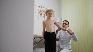 A young boy receives a medical exam, showcasing pediatric care