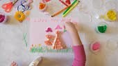 Child creating homemade greeting card. Gift for Mothers day, Birthday...