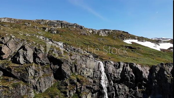 Waterfall in mountains. National tourist scenic route 55 Sognefjellet between Lom and Luster, Norway. Summertime