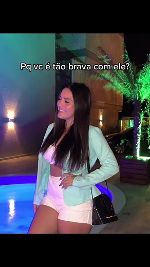 Playful Nighttime Pool Interaction between Young Couple