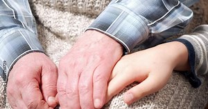 Elderly hands touching and stroking children hands. Continuity of generations. Close up hands of grandchild and grandfather.