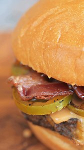 This ain't your lunchbox classic. We’re talking a juicy ½ lb fresh, never frozen beef patty, slathered in creamy peanut butter and rich bacon jam, topped with grilled jalapeños, melty Cheddar Jack cheese, and crispy bacon — all stacked on a yummy brioche bun. It’s sweet, it’s spicy, it’s salty… and it’s definitely getting sent to the principal’s office. #fatpattys #bitethis #pb&j #peanutbutterburger #fatsfeature #loveatfirstbite | Fat Pattys