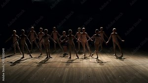 A large group of children rehearsing and dancing the ballet. A choreographed dance of a group of graceful pretty young ballerinas practicing on stage in a classical ballet school. Slow motion.