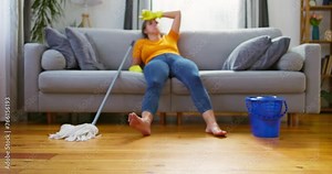 Woman resting on couch after mopping floor.