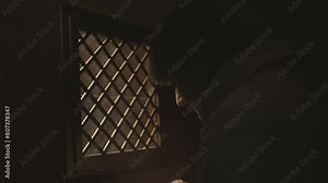 Christian woman crossing herself near confessional booth in church slow motion. Religious person praying during confession close up. Worship and faith concept