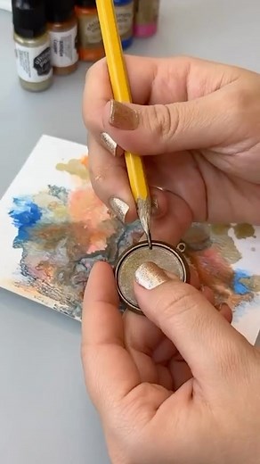 Create mixed media jewelry with our Raku patina effects kit, watercolor paper UV Resin and a natural brass bezel! #mixedmediajewelry #vintajco #uvresinjewelry | Vintaj