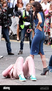 Wearing a pink suit with baby blue Nike sneakers, Robbie Williams and 'Skins' star Kaya Scodelario were spotted on set filming scenes for his new music video in East London. According to reports, Williams who is set to be a first time dad with wife Ayda Fielder, chose not to perform at the Olympics Closing Ceremony with the rest of his 'Take That' bandmates because Ayda was too pregnant to fly from LA, yet she was seen on set supporting her husband. London, UK. 16th August 2012 Stock Photo - Ala