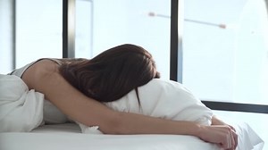 Beautiful Woman Lying On Comfortable Bed And Hugging Pillow