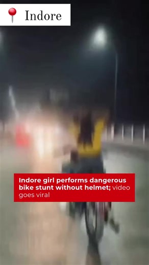#Indore | A viral video shows a young woman performing a bike stunt without a helmet, letting go of the bike with her hands, putting herself and others at serious risk. The internet is criticizing her reckless act. #BikeStunt #RoadSafety #ViralVideo #Helmet #Safety | Life Today Assam