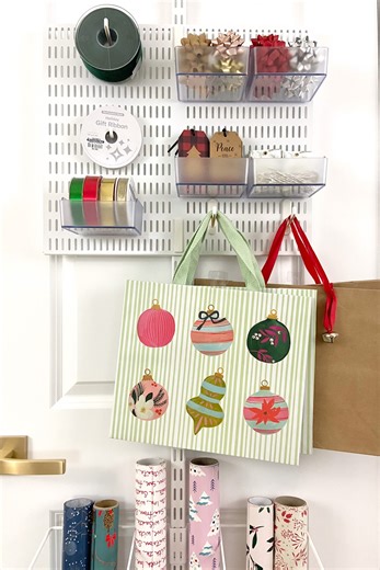 Everything Envy's key to holiday organization? The Elfa Gift Wrap Over the Door Rack! 🎁💙 Designed to make the most of often-wasted vertical space on a door or wall, The Elfa Gift Wrap Rack keeps rolls neat and easily accessible. See below the features and benefits. SHOP online: https://container.store/3RJAUqq #TheContainerStore 🎁 This innovative system is customizable. 🎁 Easy, no-tools assembly. 🎁 Utility Board with Hooks and Holders stores ribbon, tape, tags, and bags. 🎁 Mesh provides vis