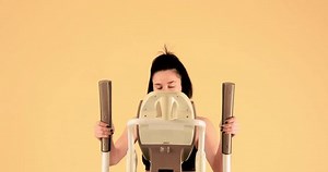 clip-3984820809-young-woman-exercises-on-elliptical-trainer-waves