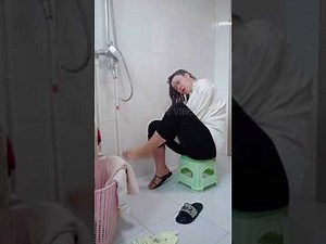 DOUBLE ABOVE ELBOW AMPUTEE LADY WASHING HAIR