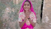 Namaste! - Portrait of happy Indian girl on a desert, sand dunes in...