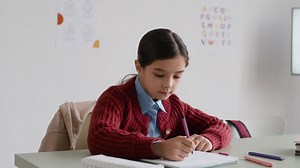 Focused Student Taking Notes in Class | Free Stock Video Footage